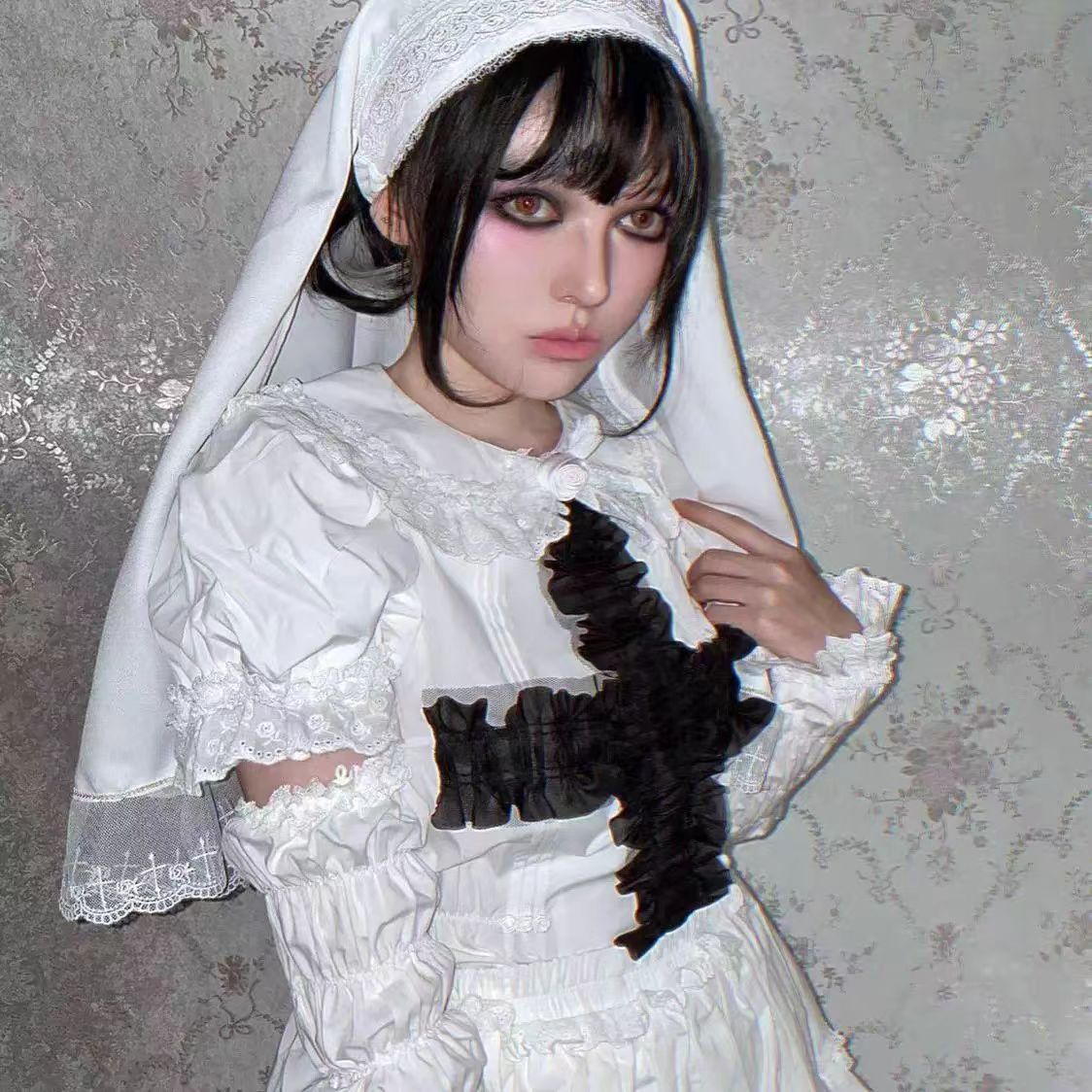 This striking headwear merges ecclesiastical elegance with punk rebellion. The adjustable elastic band ensures comfort, while the stark black-and-white veil creates dramatic draping. Perfect for adding sacred-edgy contrast to Gothic Lolita coordinations or avant-garde fashion statements. Its minimalist design embodies dark sophistication with a rebellious spirit.