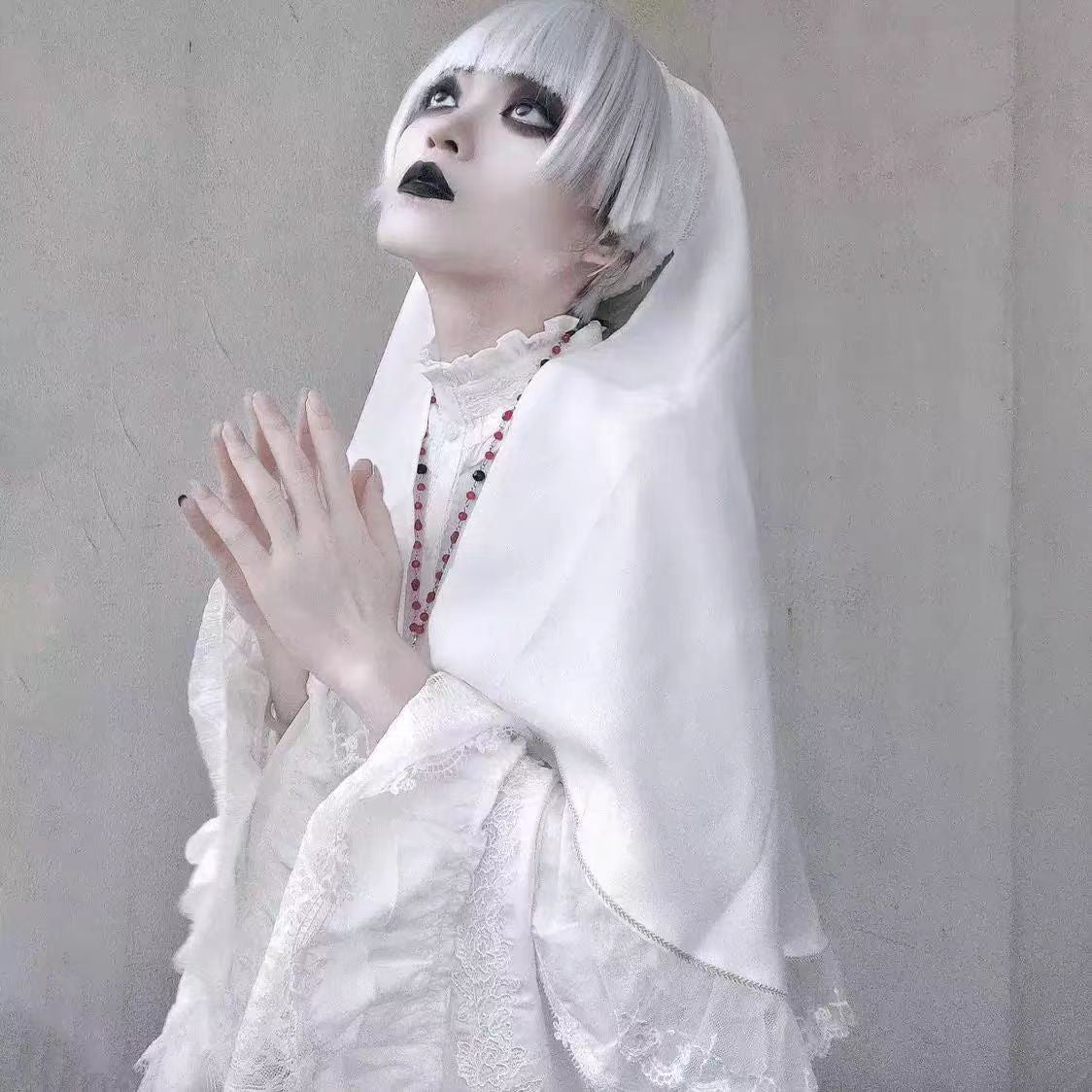 This striking headwear merges ecclesiastical elegance with punk rebellion. The adjustable elastic band ensures comfort, while the stark black-and-white veil creates dramatic draping. Perfect for adding sacred-edgy contrast to Gothic Lolita coordinations or avant-garde fashion statements. Its minimalist design embodies dark sophistication with a rebellious spirit.