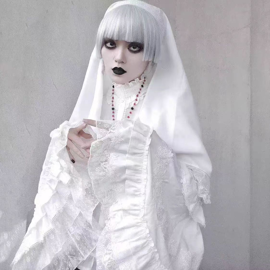 This striking headwear merges ecclesiastical elegance with punk rebellion. The adjustable elastic band ensures comfort, while the stark black-and-white veil creates dramatic draping. Perfect for adding sacred-edgy contrast to Gothic Lolita coordinations or avant-garde fashion statements. Its minimalist design embodies dark sophistication with a rebellious spirit.