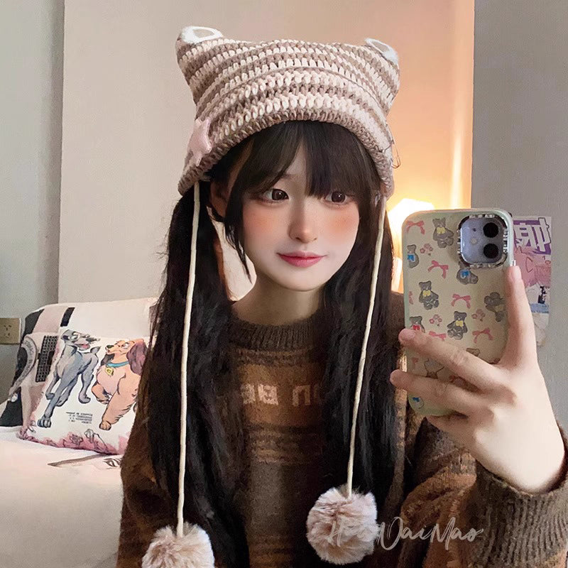 Crafted for the playful rebel, this beanie blends Y2K nostalgia with whimsical Lolita charm. The mischievous cat ears and devilish pointed silhouette are softened by a fluffy pom-pom, creating a bold yet adorable statement. Knitted from soft, stretchable yarn with vibrant stripes, it offers cozy comfort and a touch of fantasy, empowering you to express your unique blend of sweetness and rebellion in every season.