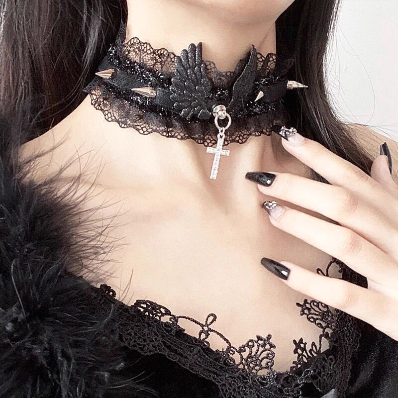 This Lolita Cyberpunk Gothic Choker Necklace fuses edgy punk style with vintage Lolita elegance. Designed with delicate lace, bold studs, and angel wing accents, it creates a striking balance of softness and rebellion. Available in classic black and white, it is a versatile accessory to match both sweet and dark Lolita outfits. Perfect for parties, photoshoots, or themed events, this choker adds a unique cyber-gothic touch to any ensemble.