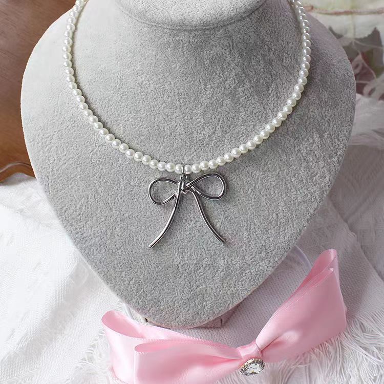 This Silver Bow Pearl Necklace combines the sweetness of pearls with the elegance of a delicate bow, creating a perfect balance of charm and style. Its silver-toned finish adds a modern touch, while the Lolita-inspired design makes it both cute and versatile. Ideal for sweet Lolita, casual chic, or cool girl aesthetics, this necklace is a must-have accessory that elevates outfits for parties, gatherings, or everyday fashion.