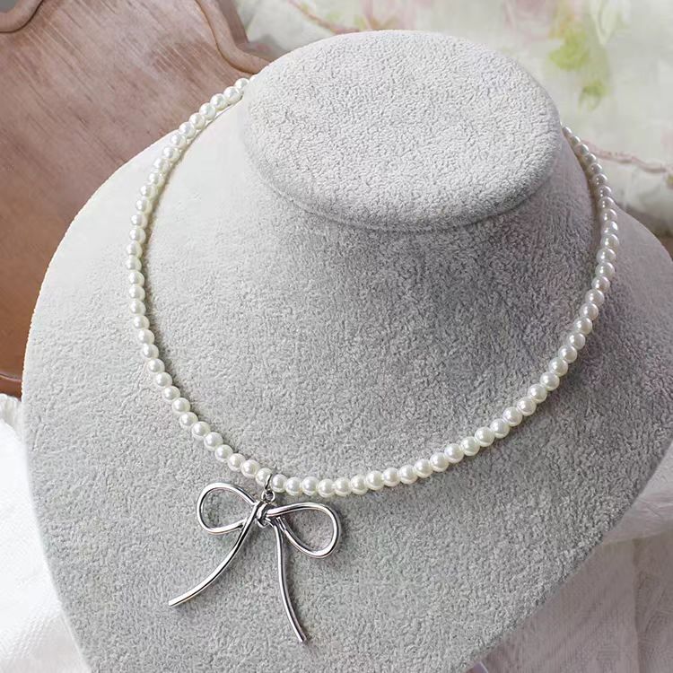 This Silver Bow Pearl Necklace combines the sweetness of pearls with the elegance of a delicate bow, creating a perfect balance of charm and style. Its silver-toned finish adds a modern touch, while the Lolita-inspired design makes it both cute and versatile. Ideal for sweet Lolita, casual chic, or cool girl aesthetics, this necklace is a must-have accessory that elevates outfits for parties, gatherings, or everyday fashion.
