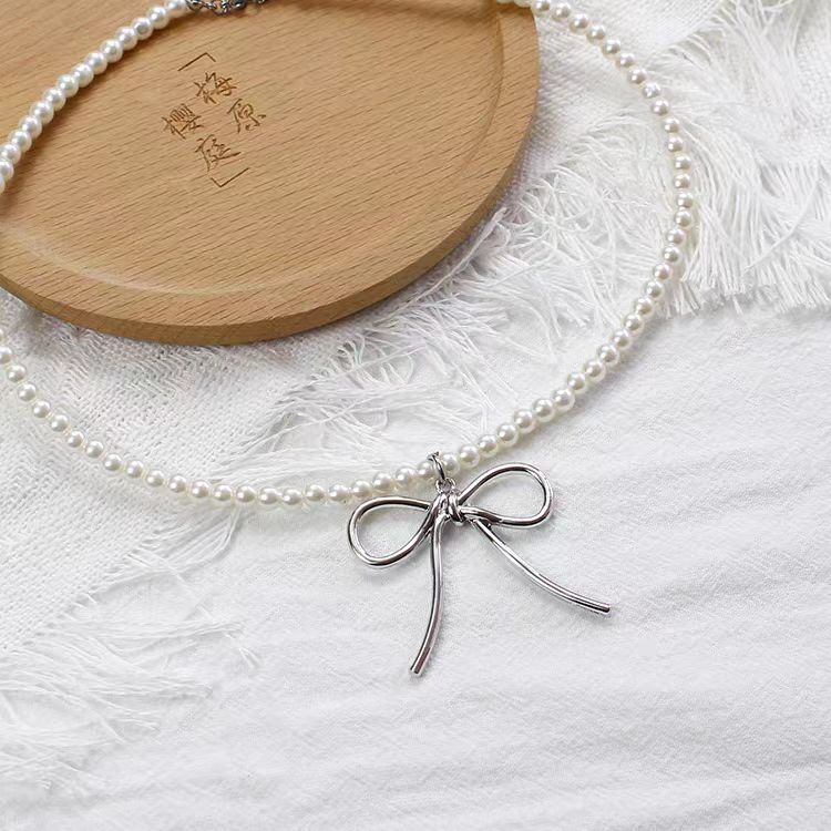 This Silver Bow Pearl Necklace combines the sweetness of pearls with the elegance of a delicate bow, creating a perfect balance of charm and style. Its silver-toned finish adds a modern touch, while the Lolita-inspired design makes it both cute and versatile. Ideal for sweet Lolita, casual chic, or cool girl aesthetics, this necklace is a must-have accessory that elevates outfits for parties, gatherings, or everyday fashion.