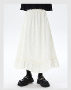 Embrace autumn’s artistry in this beige jacquard knit skirt, where texture meets timeless elegance. Delicate lace-like patterns and a subtle ruffle hem create a soft, romantic silhouette, while the elastic waist ensures effortless comfort. Crafted from premium knit fabric, this A-line midi skirt offers warmth without weight, perfect for transitional weather. Ideal for pairing with cozy sweaters or refined blouses, it blends rustic charm with sophisticated detail. Whether for café dates or evening strolls, t