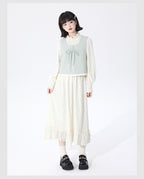 Embrace autumn’s artistry in this beige jacquard knit skirt, where texture meets timeless elegance. Delicate lace-like patterns and a subtle ruffle hem create a soft, romantic silhouette, while the elastic waist ensures effortless comfort. Crafted from premium knit fabric, this A-line midi skirt offers warmth without weight, perfect for transitional weather. Ideal for pairing with cozy sweaters or refined blouses, it blends rustic charm with sophisticated detail. Whether for café dates or evening strolls, t