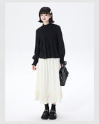 Embrace autumn’s artistry in this beige jacquard knit skirt, where texture meets timeless elegance. Delicate lace-like patterns and a subtle ruffle hem create a soft, romantic silhouette, while the elastic waist ensures effortless comfort. Crafted from premium knit fabric, this A-line midi skirt offers warmth without weight, perfect for transitional weather. Ideal for pairing with cozy sweaters or refined blouses, it blends rustic charm with sophisticated detail. Whether for café dates or evening strolls, t