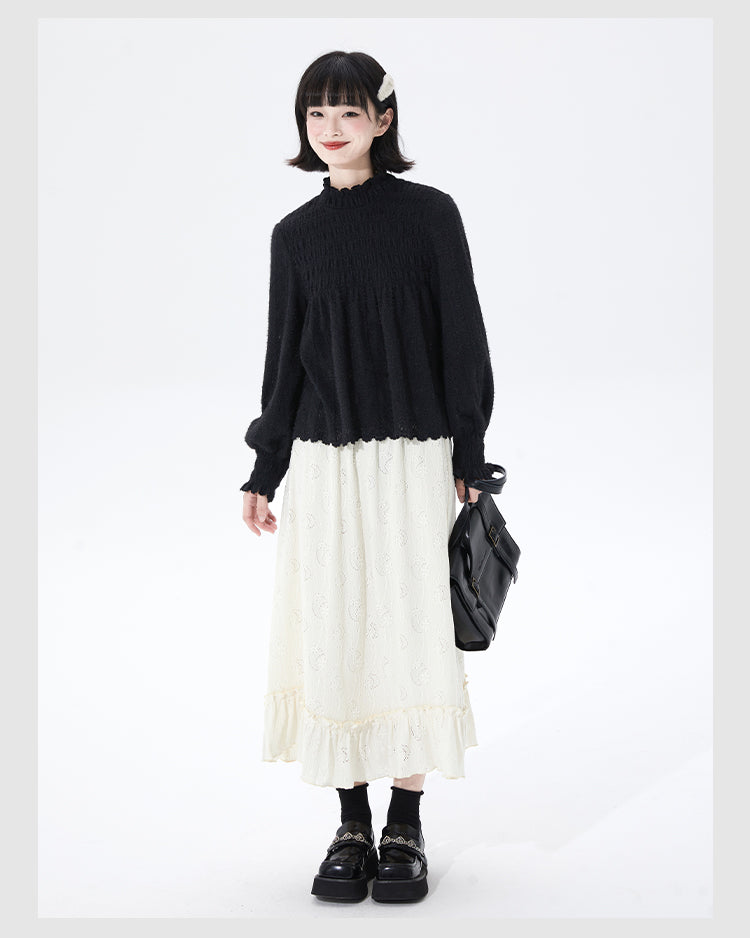 Embrace autumn’s artistry in this beige jacquard knit skirt, where texture meets timeless elegance. Delicate lace-like patterns and a subtle ruffle hem create a soft, romantic silhouette, while the elastic waist ensures effortless comfort. Crafted from premium knit fabric, this A-line midi skirt offers warmth without weight, perfect for transitional weather. Ideal for pairing with cozy sweaters or refined blouses, it blends rustic charm with sophisticated detail. Whether for café dates or evening strolls, t
