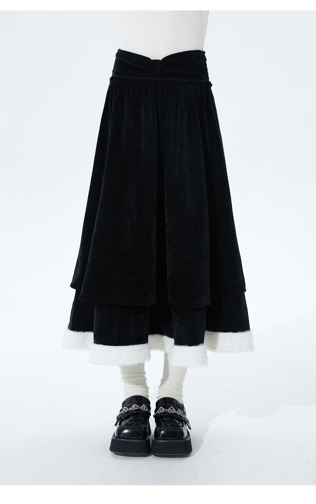 Inspired by the poetic imagery of ink butterflies shaking off snow, this skirt merges dramatic elegance with delicate romance. The bold bow accent and layered, flounced tulle hem create a sense of dynamic, snow-like movement. Designed in versatile black, it offers a timeless statement piece that transitions effortlessly from festive holiday gatherings to refined winter occasions, blending theatrical charm with wearable sophistication.