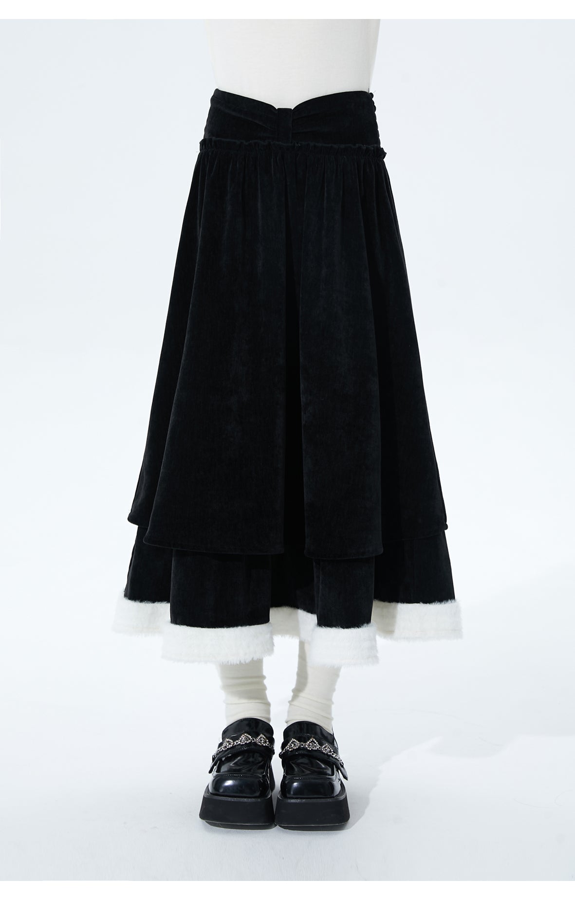 Inspired by the poetic imagery of ink butterflies shaking off snow, this skirt merges dramatic elegance with delicate romance. The bold bow accent and layered, flounced tulle hem create a sense of dynamic, snow-like movement. Designed in versatile black, it offers a timeless statement piece that transitions effortlessly from festive holiday gatherings to refined winter occasions, blending theatrical charm with wearable sophistication.