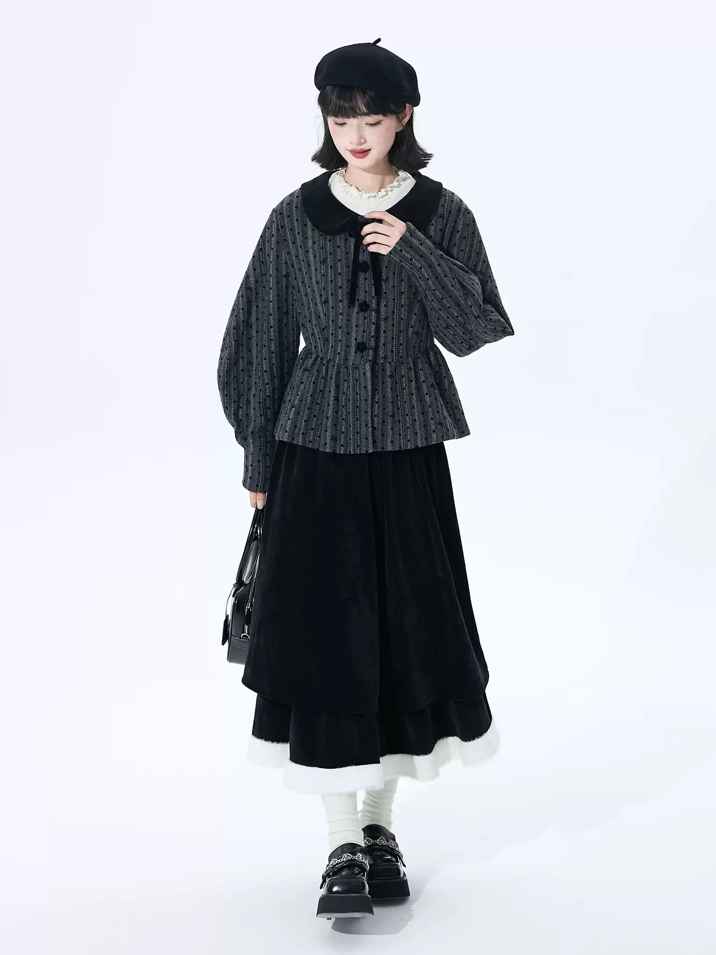 Inspired by the poetic imagery of ink butterflies shaking off snow, this skirt merges dramatic elegance with delicate romance. The bold bow accent and layered, flounced tulle hem create a sense of dynamic, snow-like movement. Designed in versatile black, it offers a timeless statement piece that transitions effortlessly from festive holiday gatherings to refined winter occasions, blending theatrical charm with wearable sophistication.