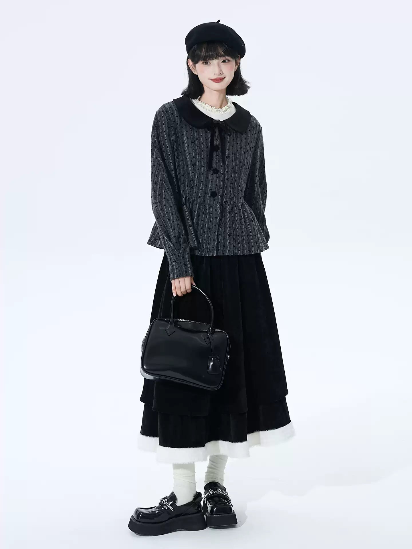 Inspired by the poetic imagery of ink butterflies shaking off snow, this skirt merges dramatic elegance with delicate romance. The bold bow accent and layered, flounced tulle hem create a sense of dynamic, snow-like movement. Designed in versatile black, it offers a timeless statement piece that transitions effortlessly from festive holiday gatherings to refined winter occasions, blending theatrical charm with wearable sophistication.