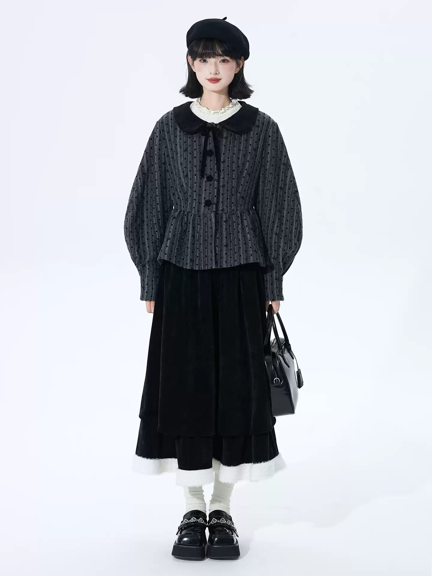 Inspired by the poetic imagery of ink butterflies shaking off snow, this skirt merges dramatic elegance with delicate romance. The bold bow accent and layered, flounced tulle hem create a sense of dynamic, snow-like movement. Designed in versatile black, it offers a timeless statement piece that transitions effortlessly from festive holiday gatherings to refined winter occasions, blending theatrical charm with wearable sophistication.