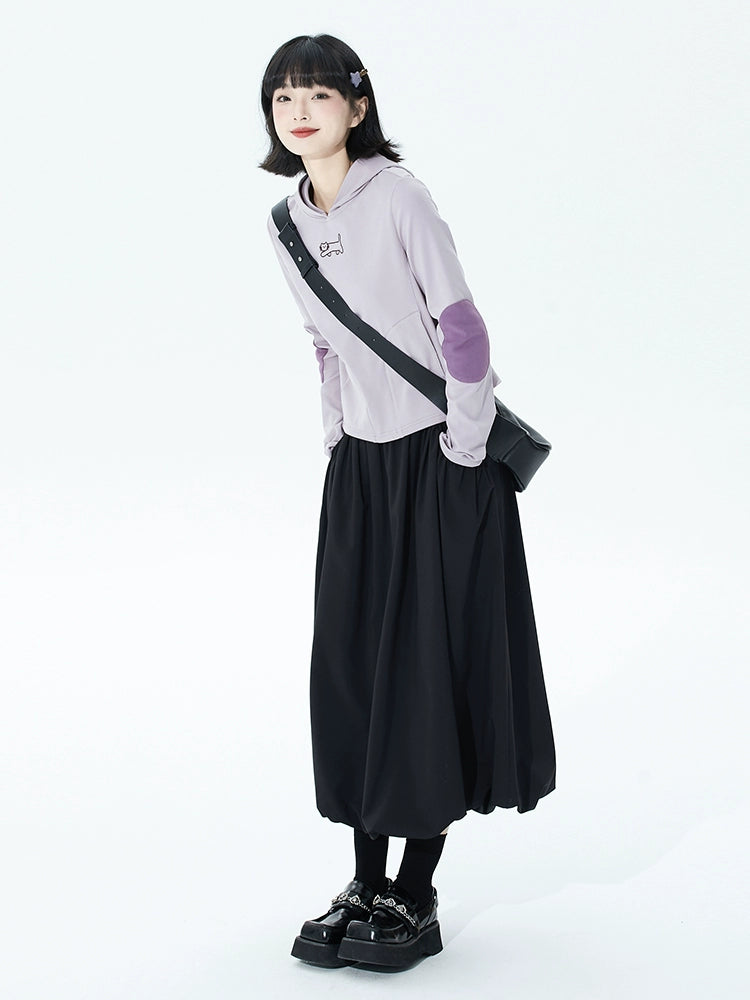 Bloom into summer elegance with this black ruffled midi skirt, designed to flatter petite frames. The elastic waist offers comfort and ease, while the gentle A-line silhouette and layered "bloom" hem create a romantic, flowing shape. Crafted from lightweight fabric for breathable warmth, this piece blends vintage charm with modern versatility. Perfect for garden parties, café dates, or elevating everyday style, it pairs effortlessly with blouses or casual tees. Embrace a touch of poetic drama and timeless g