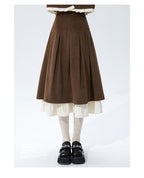 This skirt blends vintage charm with modern elegance. The high-waisted A-line silhouette and delicate pleats gracefully conceal hips and elongate the figure. A soft flounce hem adds a touch of romantic movement. Crafted from warm wool blend fabric, it's designed for both comfort and style, offering a timeless piece that transitions seamlessly from casual daytime outings to refined autumn evenings.