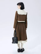 This skirt blends vintage charm with modern elegance. The high-waisted A-line silhouette and delicate pleats gracefully conceal hips and elongate the figure. A soft flounce hem adds a touch of romantic movement. Crafted from warm wool blend fabric, it's designed for both comfort and style, offering a timeless piece that transitions seamlessly from casual daytime outings to refined autumn evenings.