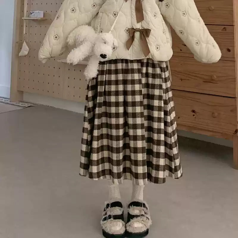 Inspired by cozy autumn days, this Chestnut skirt features an original plaid pattern in rich brown and coffee tones. Designed with a classic A-line silhouette, it effortlessly skims the body for a flattering, timeless look. Crafted from a warm and textured wool-blend fabric, it combines vintage charm with modern comfort. This versatile piece is created to be a staple in your winter wardrobe, perfect for adding a touch of rustic, intellectual elegance to any casual outing.