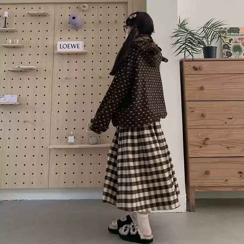 Inspired by cozy autumn days, this Chestnut skirt features an original plaid pattern in rich brown and coffee tones. Designed with a classic A-line silhouette, it effortlessly skims the body for a flattering, timeless look. Crafted from a warm and textured wool-blend fabric, it combines vintage charm with modern comfort. This versatile piece is created to be a staple in your winter wardrobe, perfect for adding a touch of rustic, intellectual elegance to any casual outing.