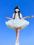 This sweet Lolita skirt combines vibrant red, green and orange hues in a playful summer design. The elastic waist ensures comfortable flexibility while layered chiffon and mesh create dynamic texture. Delicate bow accents add classic Lolita charm to this short skirt silhouette. Perfect for creating sweet or classic coordinates, this lightweight skirt offers effortless movement and timeless elegance. The cheerful color palette makes it ideal for seasonal celebrations and everyday fantasy wear.