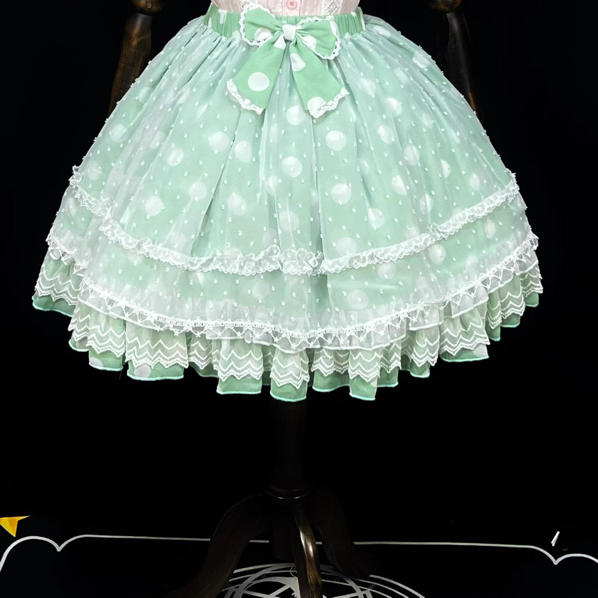 This sweet Lolita skirt combines vibrant red, green and orange hues in a playful summer design. The elastic waist ensures comfortable flexibility while layered chiffon and mesh create dynamic texture. Delicate bow accents add classic Lolita charm to this short skirt silhouette. Perfect for creating sweet or classic coordinates, this lightweight skirt offers effortless movement and timeless elegance. The cheerful color palette makes it ideal for seasonal celebrations and everyday fantasy wear.