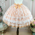 This sweet Lolita skirt combines vibrant red, green and orange hues in a playful summer design. The elastic waist ensures comfortable flexibility while layered chiffon and mesh create dynamic texture. Delicate bow accents add classic Lolita charm to this short skirt silhouette. Perfect for creating sweet or classic coordinates, this lightweight skirt offers effortless movement and timeless elegance. The cheerful color palette makes it ideal for seasonal celebrations and everyday fantasy wear.