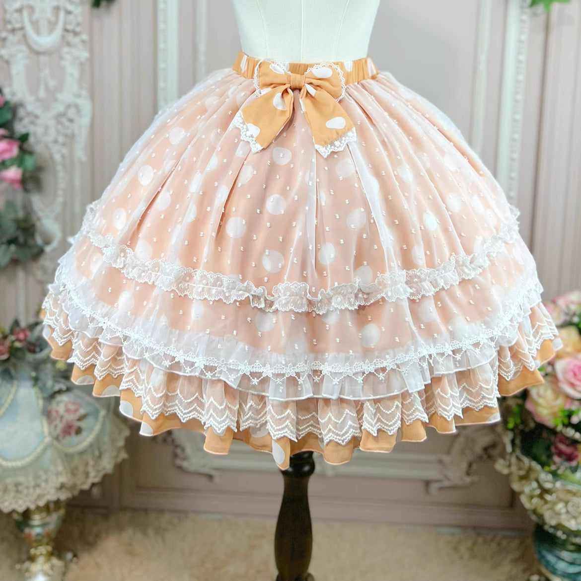 This sweet Lolita skirt combines vibrant red, green and orange hues in a playful summer design. The elastic waist ensures comfortable flexibility while layered chiffon and mesh create dynamic texture. Delicate bow accents add classic Lolita charm to this short skirt silhouette. Perfect for creating sweet or classic coordinates, this lightweight skirt offers effortless movement and timeless elegance. The cheerful color palette makes it ideal for seasonal celebrations and everyday fantasy wear.