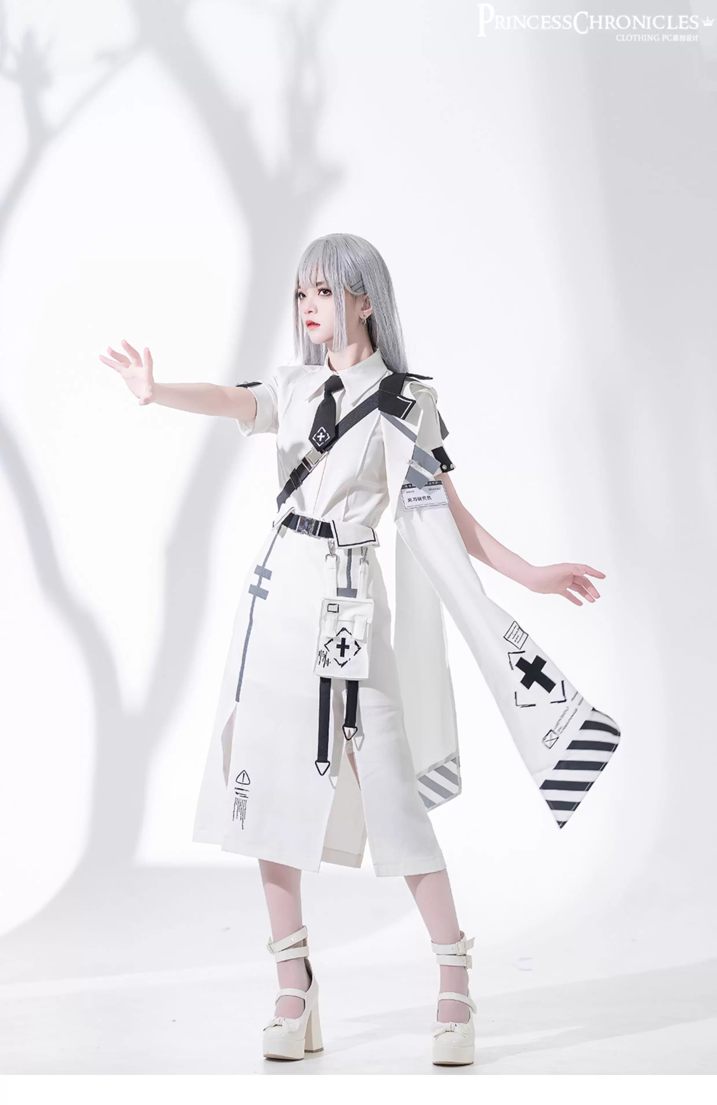 Blending Lolita’s delicate silhouette with techwear’s utilitarian edge, this skirt features asymmetric layered tiers, modular attachment points, and hidden pockets. The crisp white fabric contrasts with tactical straps and geometric seams, creating a fusion of poetic softness and cyberpunk functionality. Designed for dynamic movement and layered styling, it embodies a future where elegance meets rebellion.