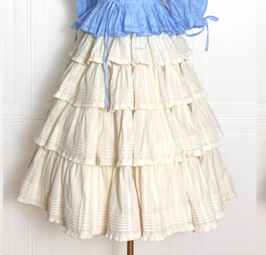Embrace rustic charm with this Heidi-inspired cottagecore Lolita skirt, crafted from premium heavy cotton for structured elegance. Meticulous embroidery and delicate trims adorn its flowing silhouette, echoing the whimsy of alpine meadows and storybook dreams. Designed for layering or standalone wear, this skirt offers versatility and timeless appeal. Available in multiple nature-inspired hues, it effortlessly complements blouses or JSKs for a pastoral yet polished coordinate. Perfect for tea parties, garde