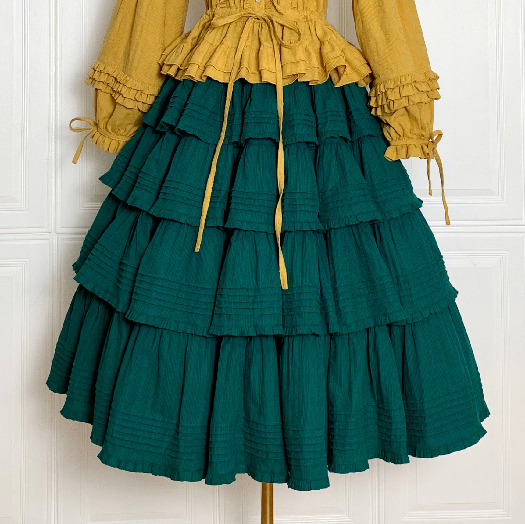 Embrace rustic charm with this Heidi-inspired cottagecore Lolita skirt, crafted from premium heavy cotton for structured elegance. Meticulous embroidery and delicate trims adorn its flowing silhouette, echoing the whimsy of alpine meadows and storybook dreams. Designed for layering or standalone wear, this skirt offers versatility and timeless appeal. Available in multiple nature-inspired hues, it effortlessly complements blouses or JSKs for a pastoral yet polished coordinate. Perfect for tea parties, garde