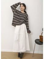 The Muse Society A-line skirt combines minimalist elegance with thoughtful design. The high-waisted cut and strategic pleating work to flatter your silhouette, effortlessly smoothing the waist and hips for a slimming effect. Crafted from a soft, breathable cotton-blend fabric, it ensures all-day comfort. This versatile skirt is designed to be a timeless, ageless staple in your wardrobe, perfect for creating a chic and polished look that transitions seamlessly across seasons.