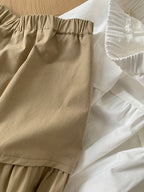 The Muse Society A-line skirt combines minimalist elegance with thoughtful design. The high-waisted cut and strategic pleating work to flatter your silhouette, effortlessly smoothing the waist and hips for a slimming effect. Crafted from a soft, breathable cotton-blend fabric, it ensures all-day comfort. This versatile skirt is designed to be a timeless, ageless staple in your wardrobe, perfect for creating a chic and polished look that transitions seamlessly across seasons.