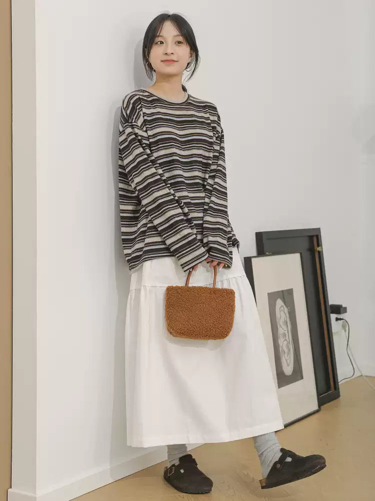 The Muse Society A-line skirt combines minimalist elegance with thoughtful design. The high-waisted cut and strategic pleating work to flatter your silhouette, effortlessly smoothing the waist and hips for a slimming effect. Crafted from a soft, breathable cotton-blend fabric, it ensures all-day comfort. This versatile skirt is designed to be a timeless, ageless staple in your wardrobe, perfect for creating a chic and polished look that transitions seamlessly across seasons.