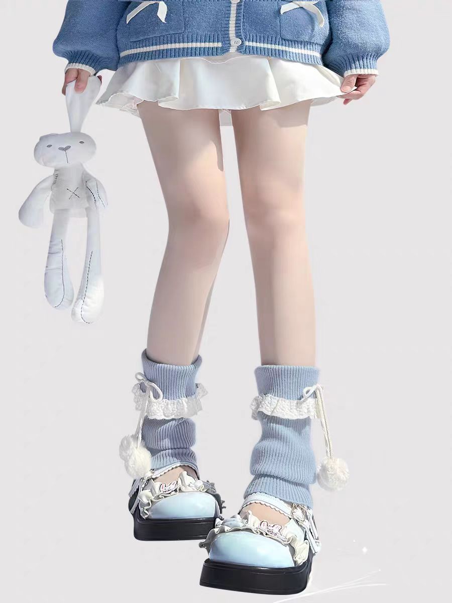 Inspired by the cozy kawaii aesthetics of Japanese street fashion, these knit leg warmers blend playful charm with winter comfort. The delicate lace trim, fluffy pompom details, and soft cream-pink color palette evoke a sweet Lolita vibe. Perfect for layering in fall and winter, they add a touch of dreamy elegance to any outfit while keeping you warm and stylish.