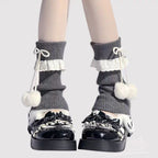 Inspired by the cozy kawaii aesthetics of Japanese street fashion, these knit leg warmers blend playful charm with winter comfort. The delicate lace trim, fluffy pompom details, and soft cream-pink color palette evoke a sweet Lolita vibe. Perfect for layering in fall and winter, they add a touch of dreamy elegance to any outfit while keeping you warm and stylish.