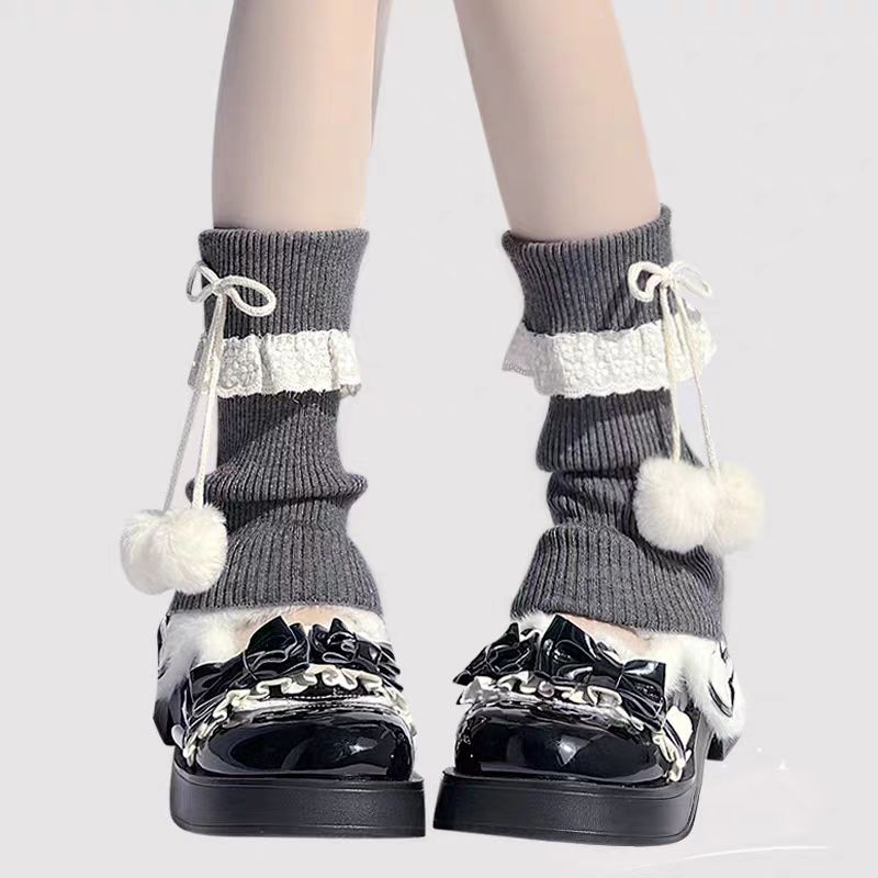 Inspired by the cozy kawaii aesthetics of Japanese street fashion, these knit leg warmers blend playful charm with winter comfort. The delicate lace trim, fluffy pompom details, and soft cream-pink color palette evoke a sweet Lolita vibe. Perfect for layering in fall and winter, they add a touch of dreamy elegance to any outfit while keeping you warm and stylish.