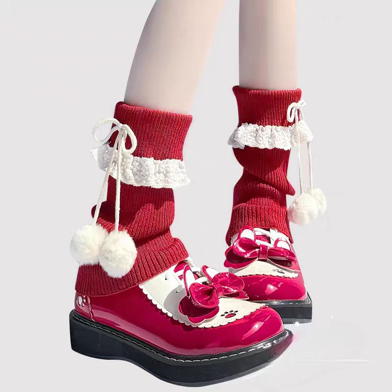Inspired by the cozy kawaii aesthetics of Japanese street fashion, these knit leg warmers blend playful charm with winter comfort. The delicate lace trim, fluffy pompom details, and soft cream-pink color palette evoke a sweet Lolita vibe. Perfect for layering in fall and winter, they add a touch of dreamy elegance to any outfit while keeping you warm and stylish.