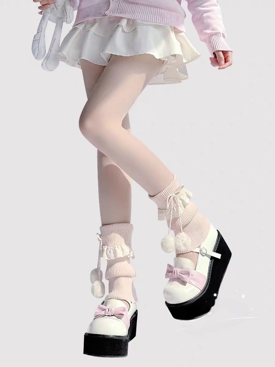 Inspired by the cozy kawaii aesthetics of Japanese street fashion, these knit leg warmers blend playful charm with winter comfort. The delicate lace trim, fluffy pompom details, and soft cream-pink color palette evoke a sweet Lolita vibe. Perfect for layering in fall and winter, they add a touch of dreamy elegance to any outfit while keeping you warm and stylish.