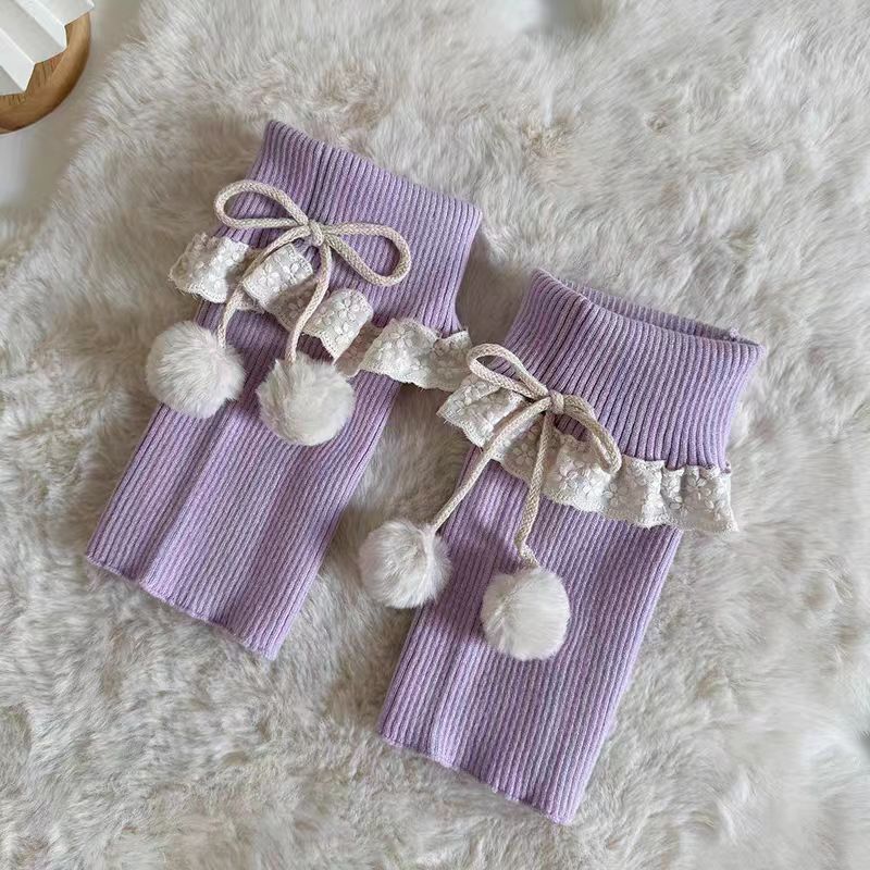 Inspired by the cozy kawaii aesthetics of Japanese street fashion, these knit leg warmers blend playful charm with winter comfort. The delicate lace trim, fluffy pompom details, and soft cream-pink color palette evoke a sweet Lolita vibe. Perfect for layering in fall and winter, they add a touch of dreamy elegance to any outfit while keeping you warm and stylish.