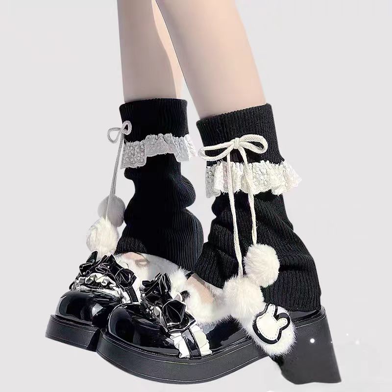 Inspired by the cozy kawaii aesthetics of Japanese street fashion, these knit leg warmers blend playful charm with winter comfort. The delicate lace trim, fluffy pompom details, and soft cream-pink color palette evoke a sweet Lolita vibe. Perfect for layering in fall and winter, they add a touch of dreamy elegance to any outfit while keeping you warm and stylish.