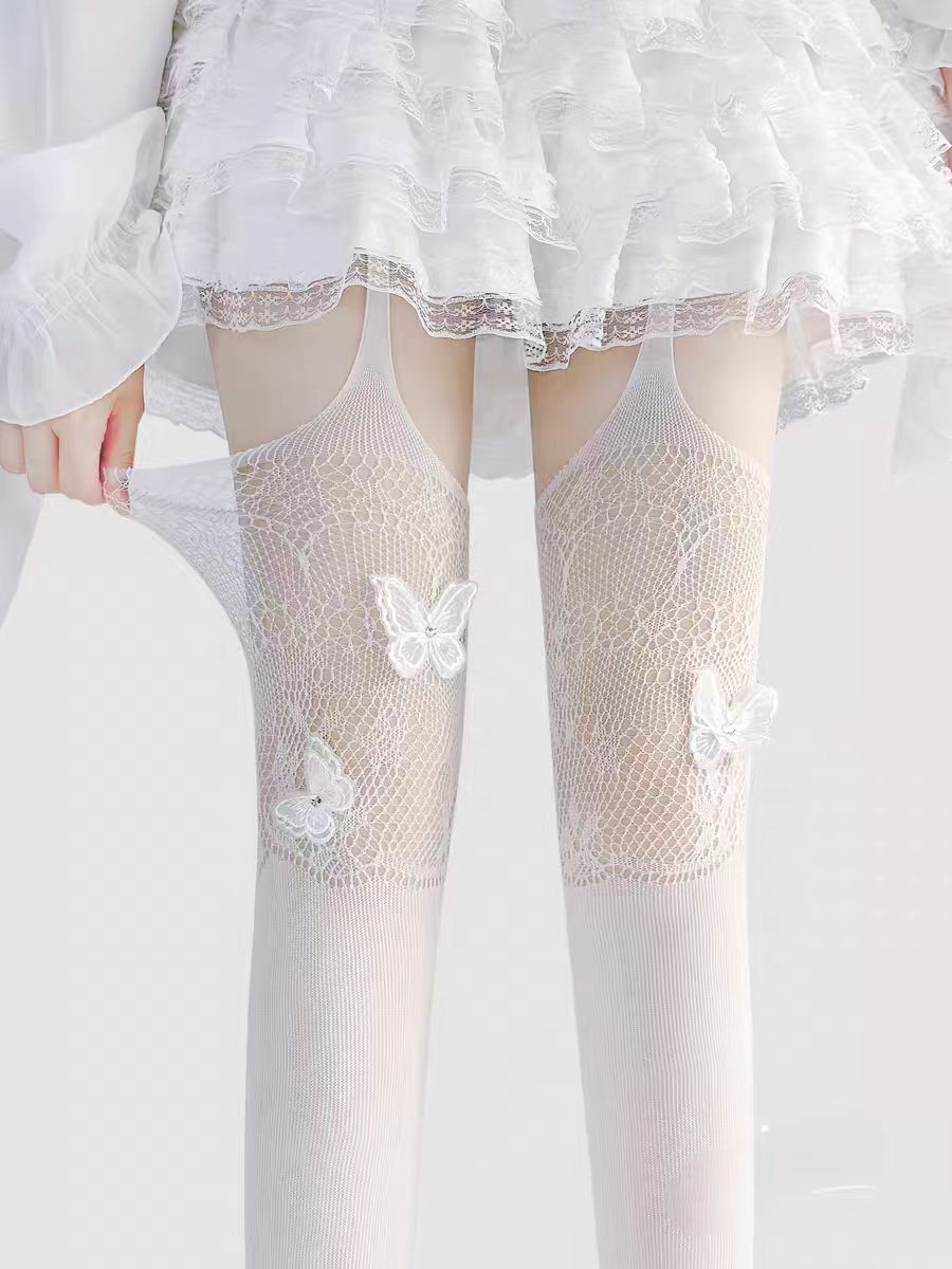 Designed for the bold and glamorous, these fishnet tights redefine edgy elegance. Delicate butterfly motifs adorned with sparkling rhinestones create a striking contrast against the sheer net fabric. The intricate strappy design and lace detailing add a touch of provocative sophistication, perfect for making a statement night out or elevating any daring fashion ensemble. Confidence woven into every thread.