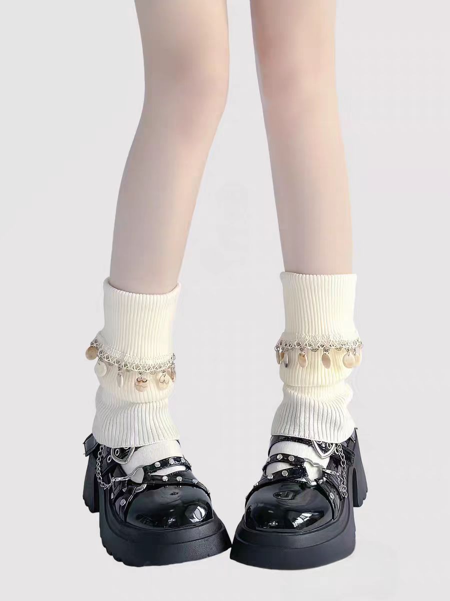 Inspired by Japanese school fashion and winter coziness, these knit leg warmers combine playful charm with warmth. The soft cream color, fluffy pom-pom detail, and fold-over fringe design create a sweet, nostalgic aesthetic. Perfect for pairing with JK uniforms or casual outfits, they offer both style and comfort during the chilly seasons.