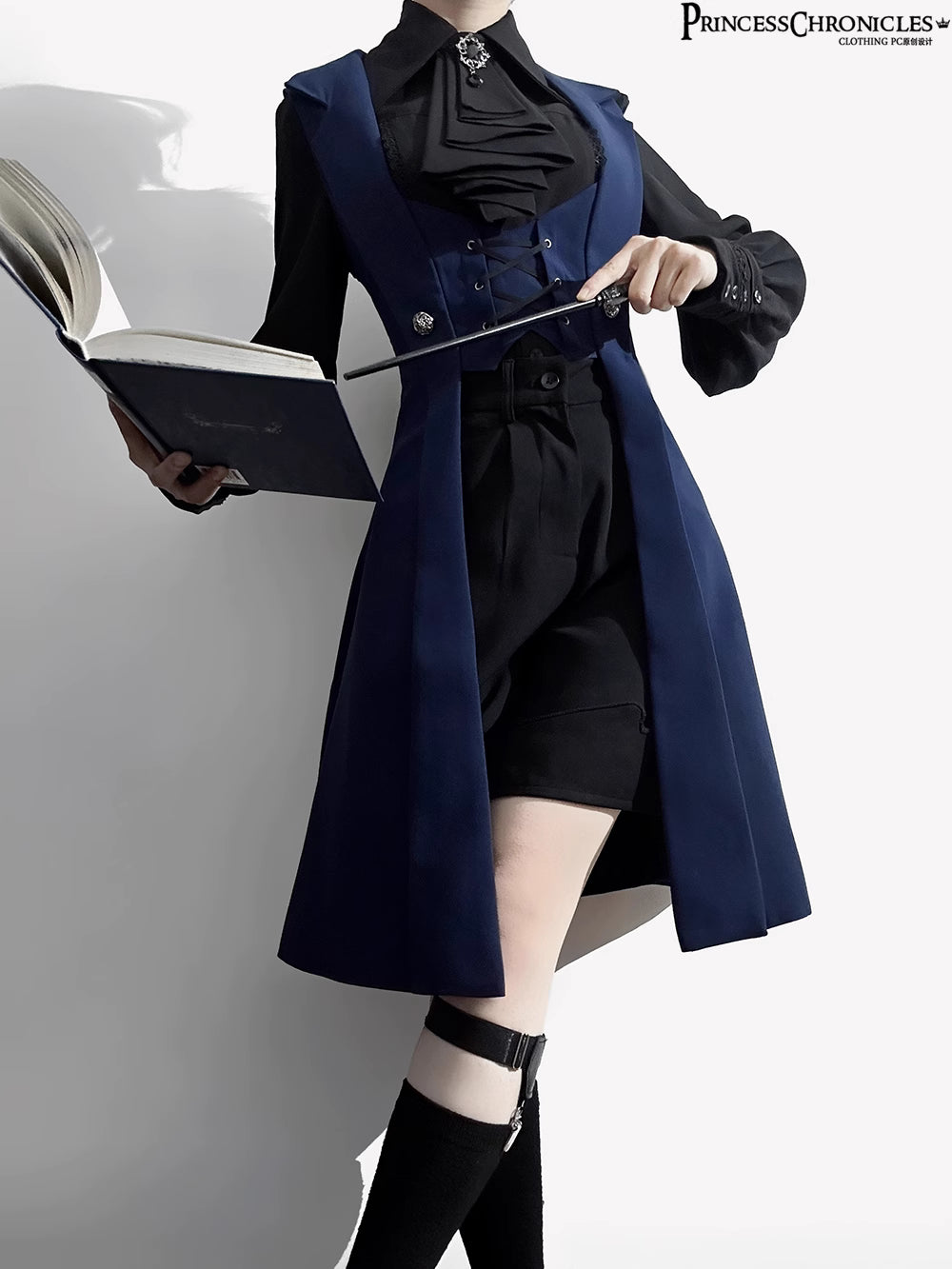 Inspired by midnight sonatas and medieval armor, this long vest merges dark romance with sharp tailoring. The deep blue hue evokes twilight mystery, while structured seams and a slim silhouette create a modern yet timeless profile. Crafted from heavy-duty twill with subtle metallic hardware, it layers over blouses or dresses to transform any outfit into a narrative of shadowy elegance and poetic rebellion.
