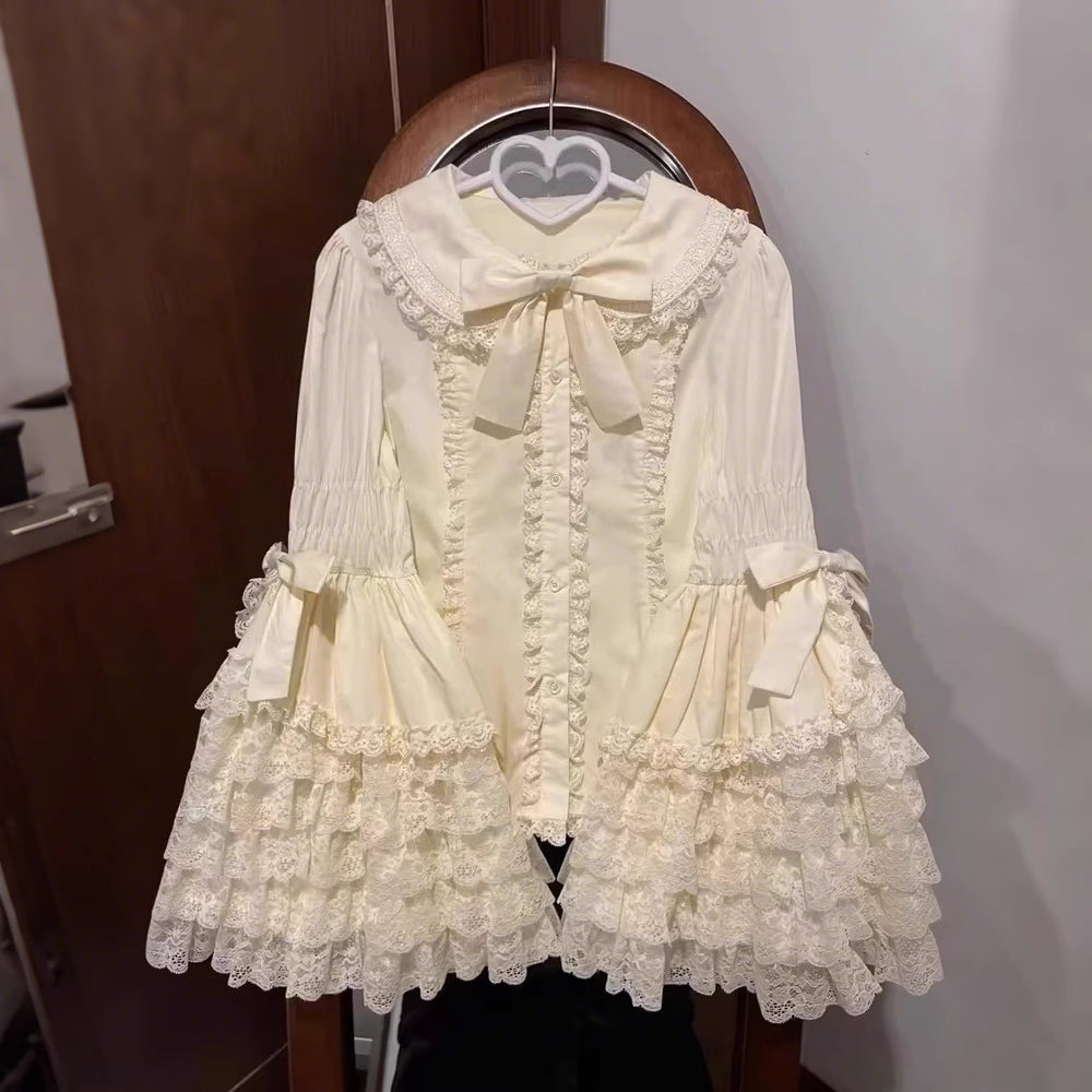 Inspired by antique porcelain dolls and Victorian elegance, this blouse features dramatic gigot sleeves, delicate lace trim, and a tailored yet forgiving fit. The ivory and black color options evoke timeless sophistication, while lightweight fabric ensures comfort. Designed to layer under jumperskirts or wear standalone, it celebrates opulent nostalgia with modern inclusivity. Perfect for creating a poetic, romantic silhouette.