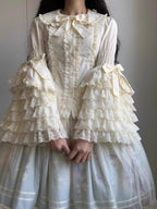 Inspired by antique porcelain dolls and Victorian elegance, this blouse features dramatic gigot sleeves, delicate lace trim, and a tailored yet forgiving fit. The ivory and black color options evoke timeless sophistication, while lightweight fabric ensures comfort. Designed to layer under jumperskirts or wear standalone, it celebrates opulent nostalgia with modern inclusivity. Perfect for creating a poetic, romantic silhouette.