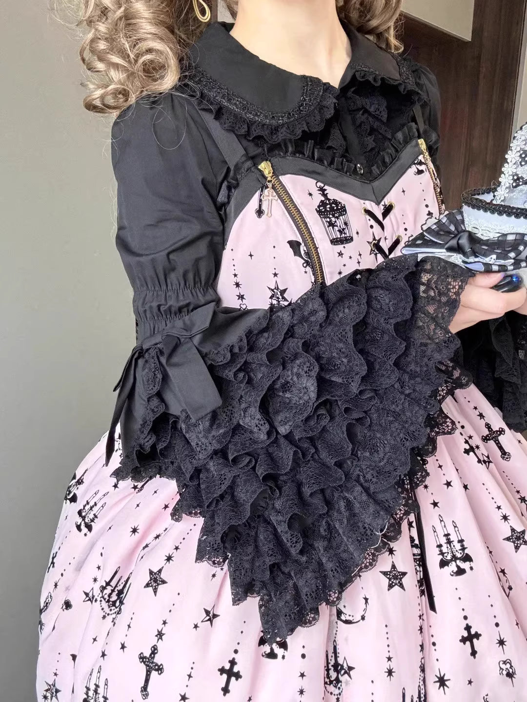 Inspired by antique porcelain dolls and Victorian elegance, this blouse features dramatic gigot sleeves, delicate lace trim, and a tailored yet forgiving fit. The ivory and black color options evoke timeless sophistication, while lightweight fabric ensures comfort. Designed to layer under jumperskirts or wear standalone, it celebrates opulent nostalgia with modern inclusivity. Perfect for creating a poetic, romantic silhouette.