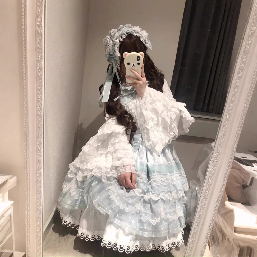 Inspired by antique porcelain dolls and Victorian elegance, this blouse features dramatic gigot sleeves, delicate lace trim, and a tailored yet forgiving fit. The ivory and black color options evoke timeless sophistication, while lightweight fabric ensures comfort. Designed to layer under jumperskirts or wear standalone, it celebrates opulent nostalgia with modern inclusivity. Perfect for creating a poetic, romantic silhouette.
