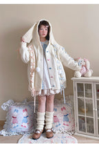 Inspired by fairy-tale whimsy, this hooded cardigan features soft bunny ear details and a playful tie-front design. Crafted from plush, cozy knit, it combines adorable charm with practical warmth for autumn and winter. The creamy white hue and rounded silhouette evoke a sugary sweetness, perfect for layering over dresses or pairing with skirts—a delightful blend of childhood nostalgia and wearable comfort.