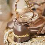 Inspired by the opulence of 19th-century Victorian soirées and the delicate artistry of heirloom jewelry, these shoes embody timeless romance. Each detail—from the lustrous pearls to the intricate lace ribbons—evokes a narrative of elegance and grace, designed for those who believe fashion is a preserved art form