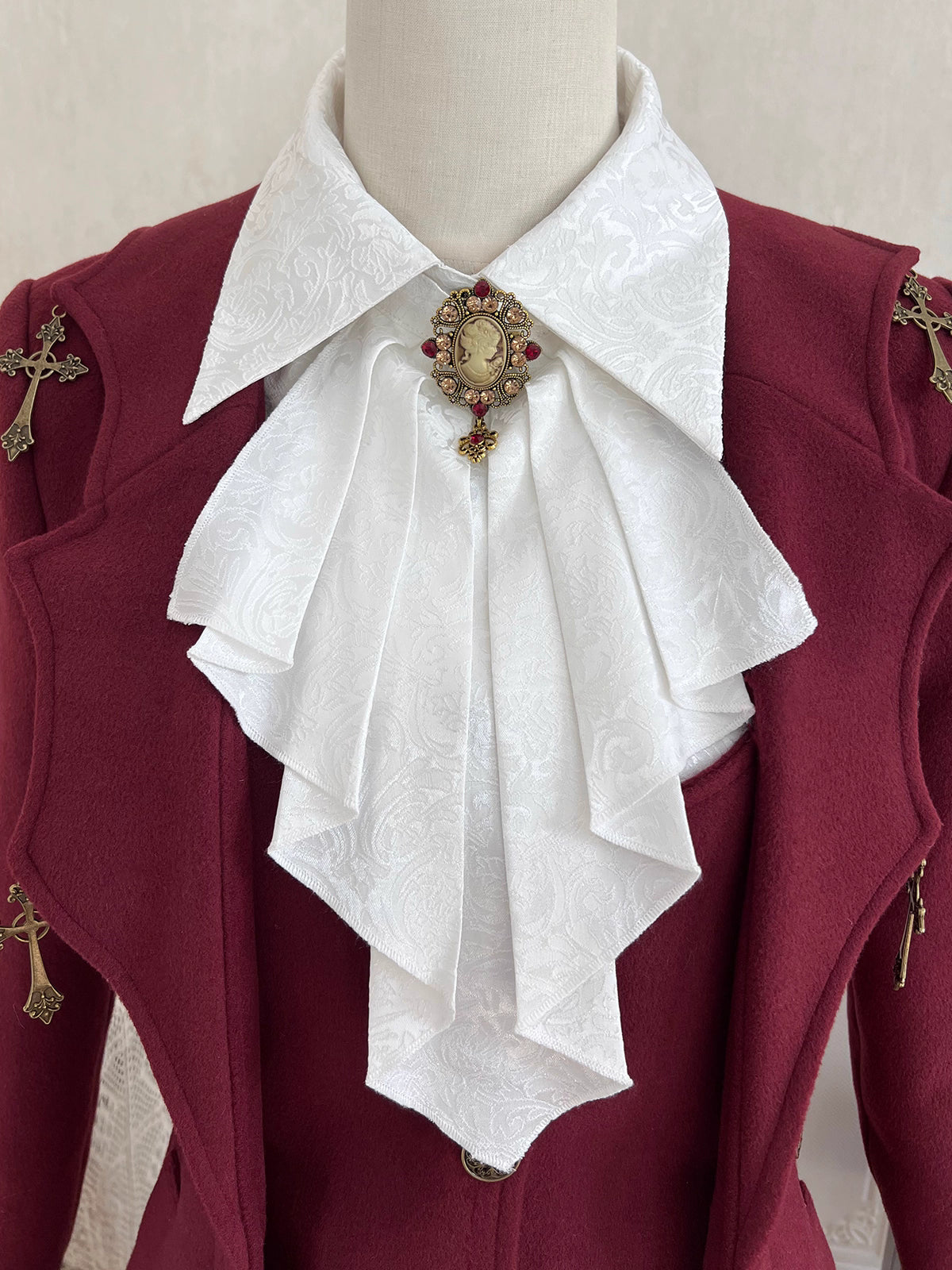 Inspired by the elegance of Gothic aristocracy, this white inner shirt combines Victorian purity with Dracula's enigmatic allure. Delicate lace trims and ruffled cuffs echo medieval romance, while crisp cotton fabric ensures refined comfort. Designed as a versatile layering piece, it contrasts dramatically with dark outer garments, embodying both innocence and mystery—a timeless base for creating captivating Ouji-Lolita ensembles.