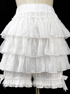 These delicate safety shorts combine functionality with Lolita aesthetics. Featuring lace-trimmed tiers and a bloomer-inspired design, they provide discreet coverage under skirts and dresses. Rendered in classic black and white, the lightweight fabric ensures comfort while adding a romantic touch to any coordination. Perfect for both sweet and Gothic styles, they offer practical elegance for dynamic wear.